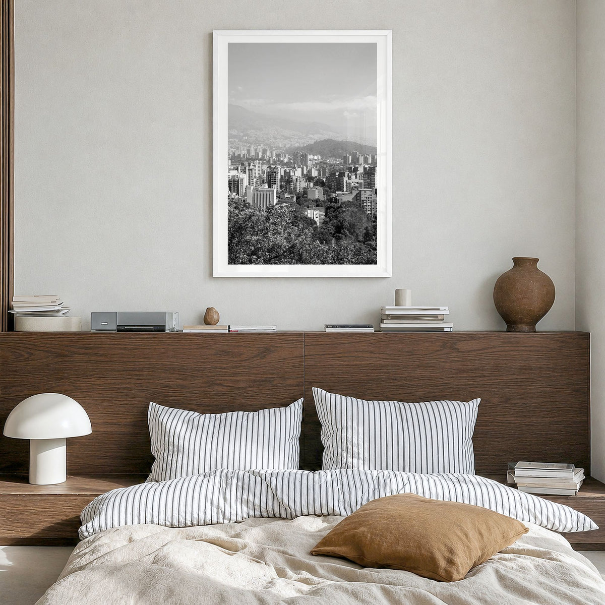 Medellín Photo Poster in a white wood frame, hanging in a bedroom, white border