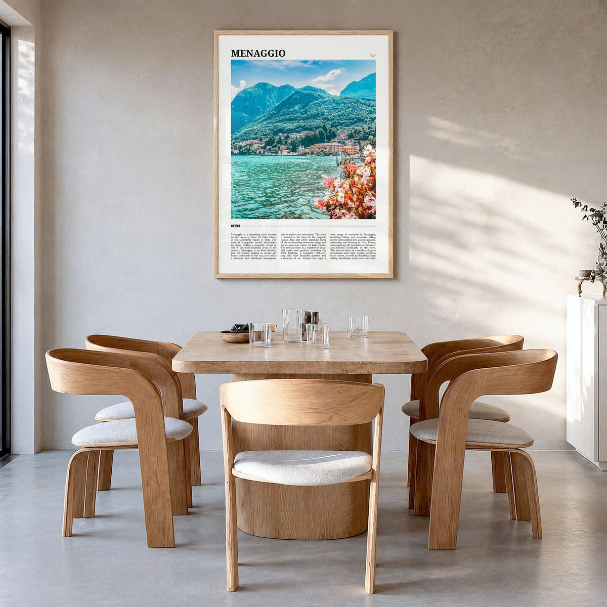 Menaggio Travel Poster in a natural wood frame, hanging in a dining room