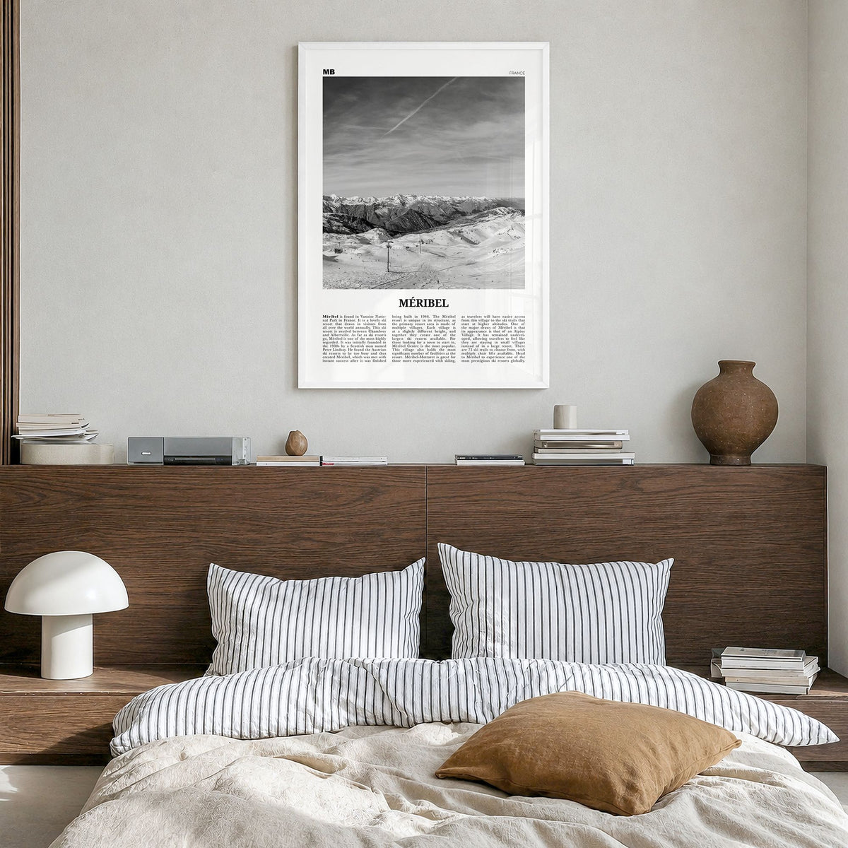 Méribel Newspaper Poster in a white wood frame, hanging in a bedroom