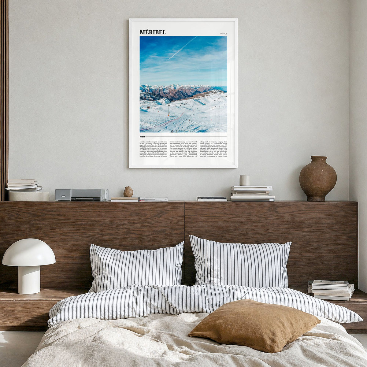 Méribel Travel Poster in a white wood frame, hanging in a bedroom