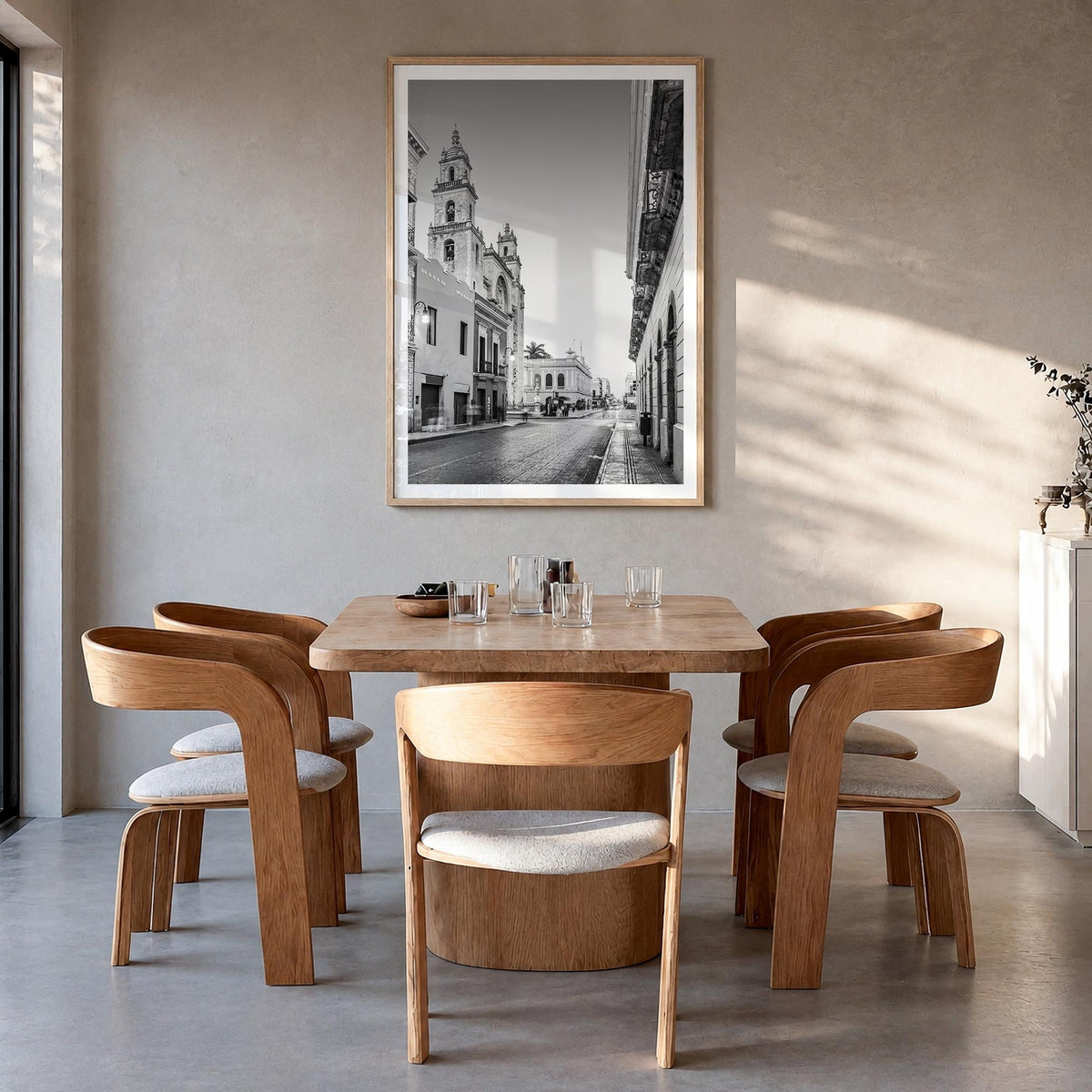 Mérida black & white photo poster of Mexico – vertical wall art in natural wood frame with white border, hanging on wall