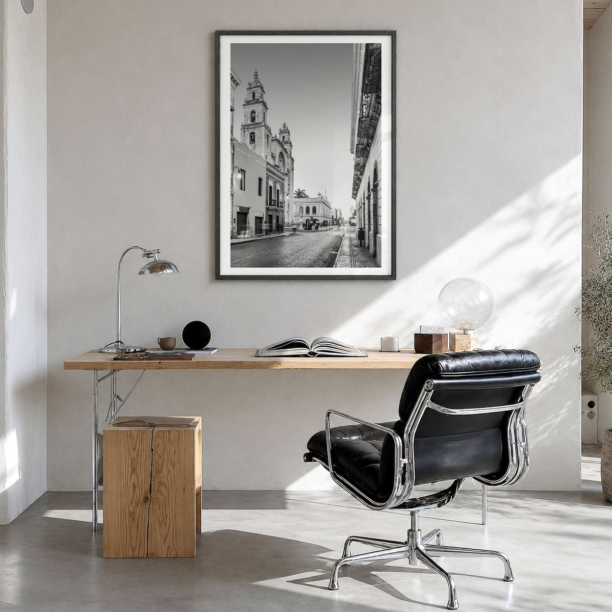Mérida Photo Poster in a black wood frame, hanging in a bright home office, white border