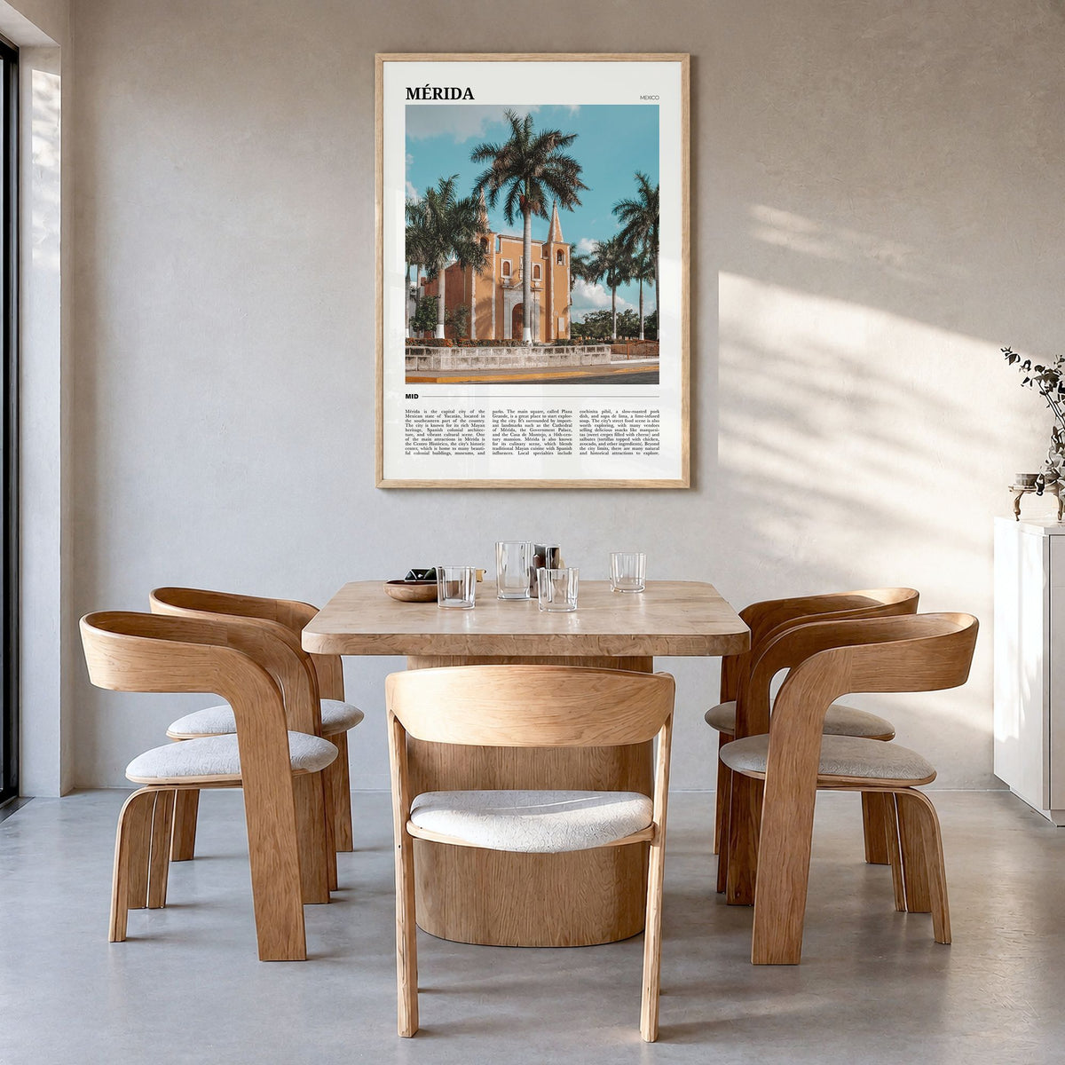 Mérida Travel Poster in a natural wood frame, hanging in a dining room