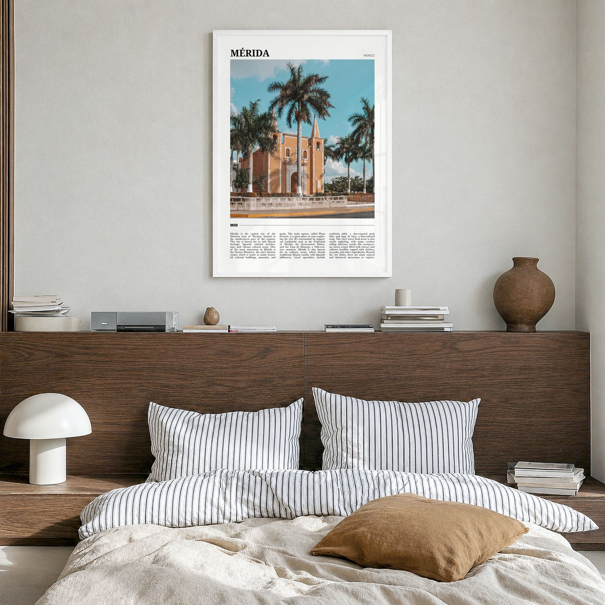 Mérida Travel Poster in a white wood frame, hanging in a bedroom