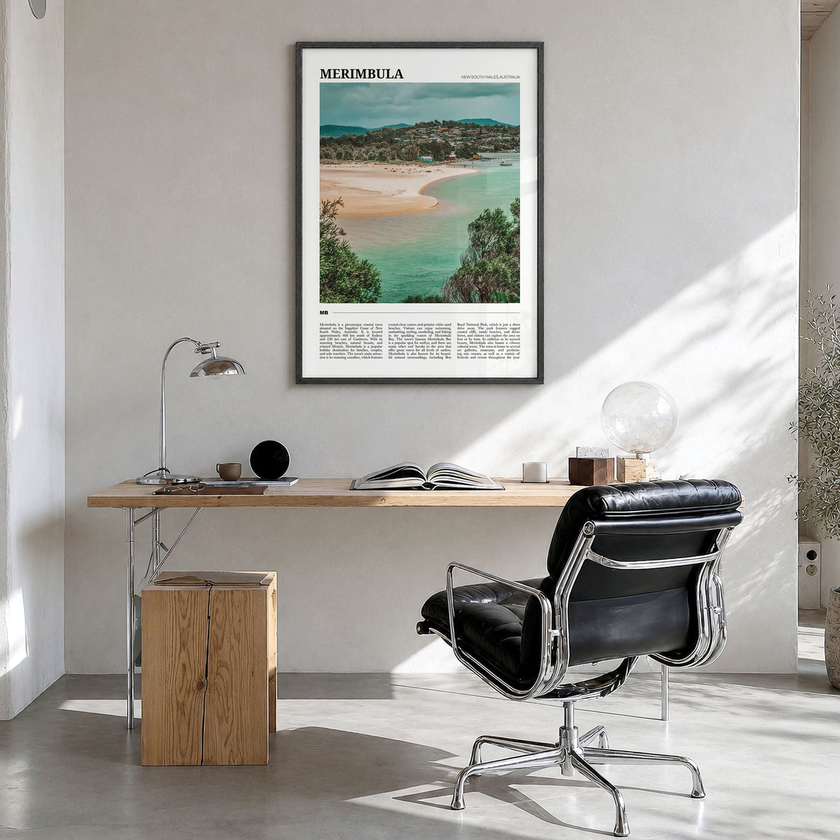 Merimbula Travel Poster in a black wood frame, hanging in a bright home office