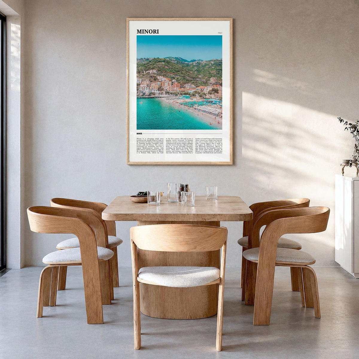 Minori Travel Poster in a natural wood frame, hanging in a dining room