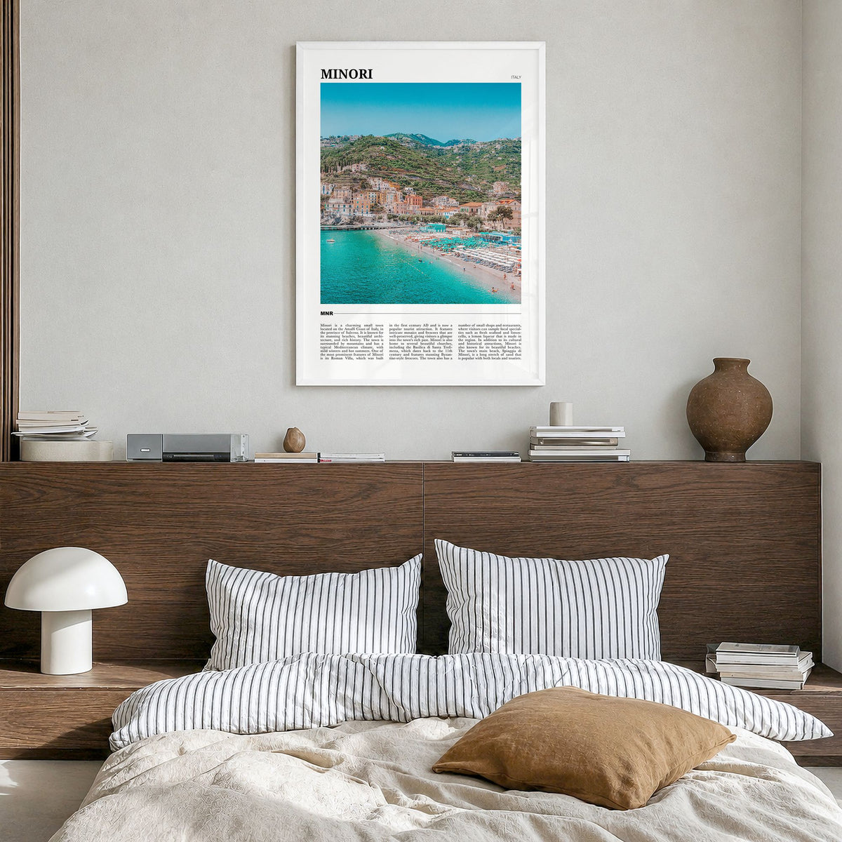 Minori Travel Poster in a white wood frame, hanging in a bedroom