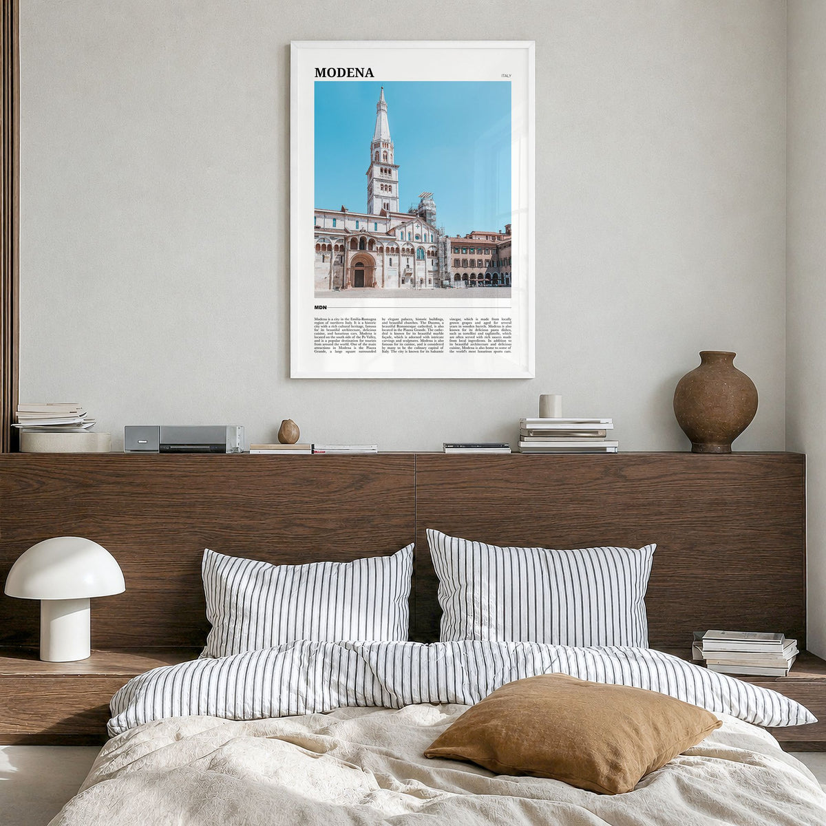 Modena Travel Poster in a white wood frame, hanging in a bedroom