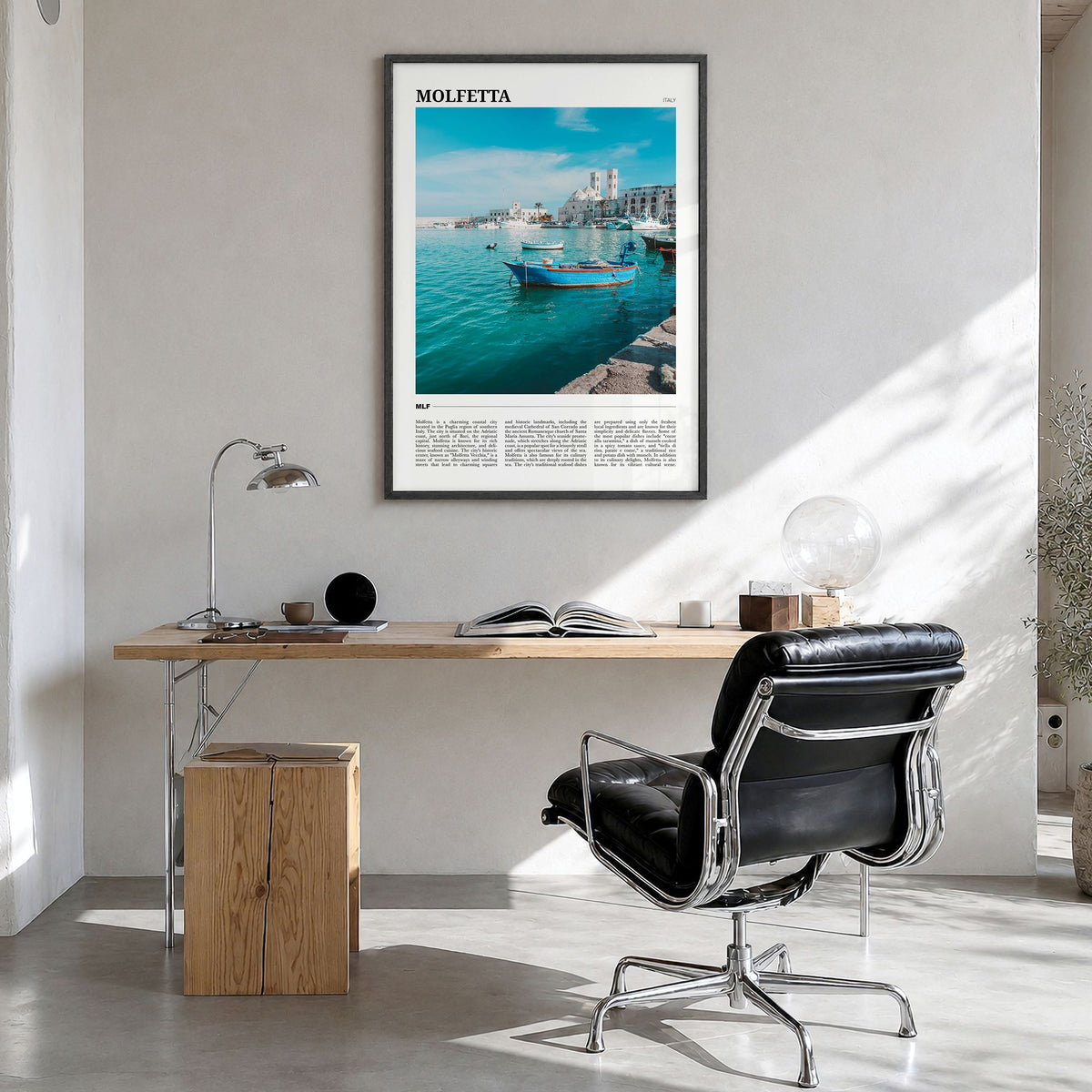 Molfetta Travel Poster in a black wood frame, hanging in a bright home office