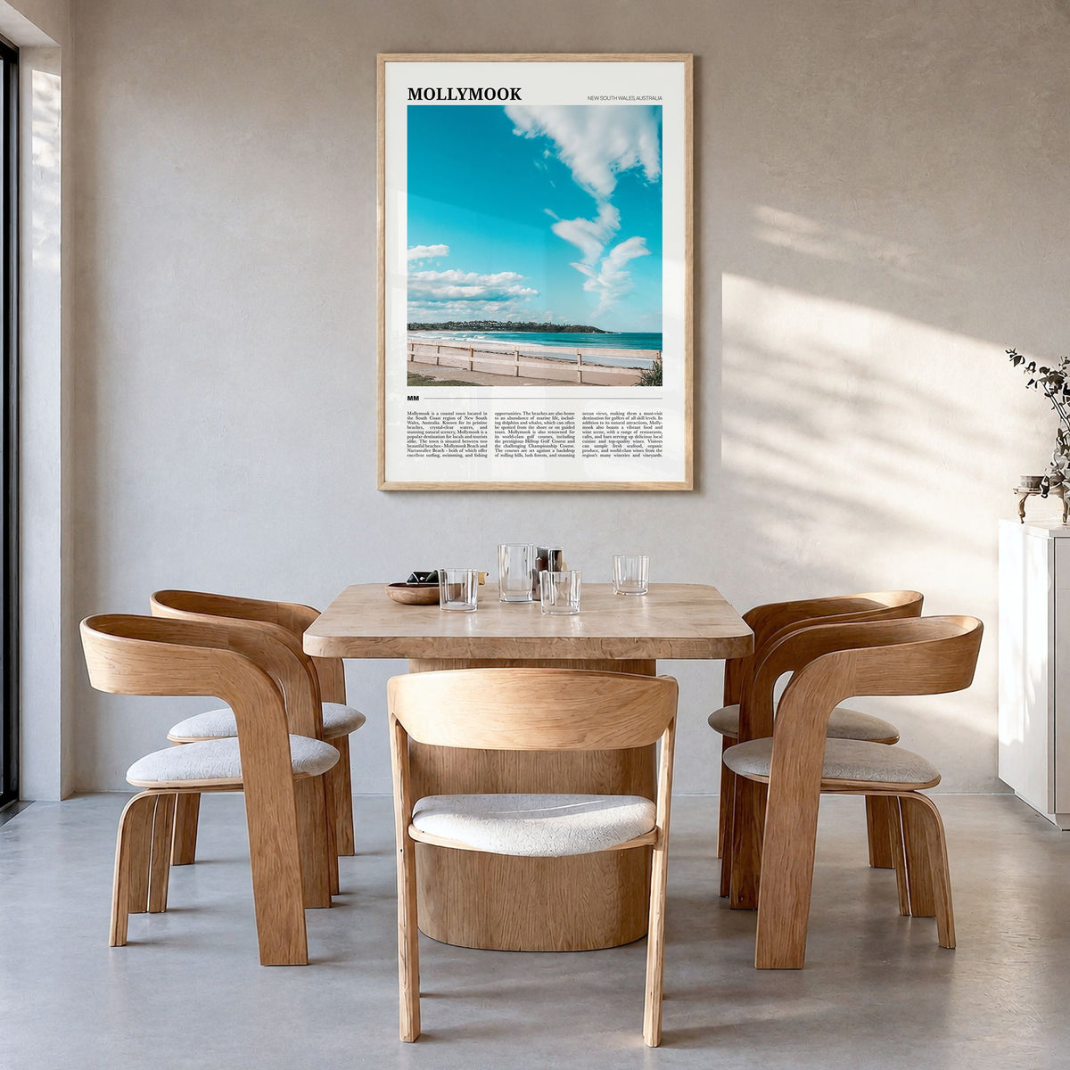 Mollymook Travel Poster in a natural wood frame, hanging in a dining room
