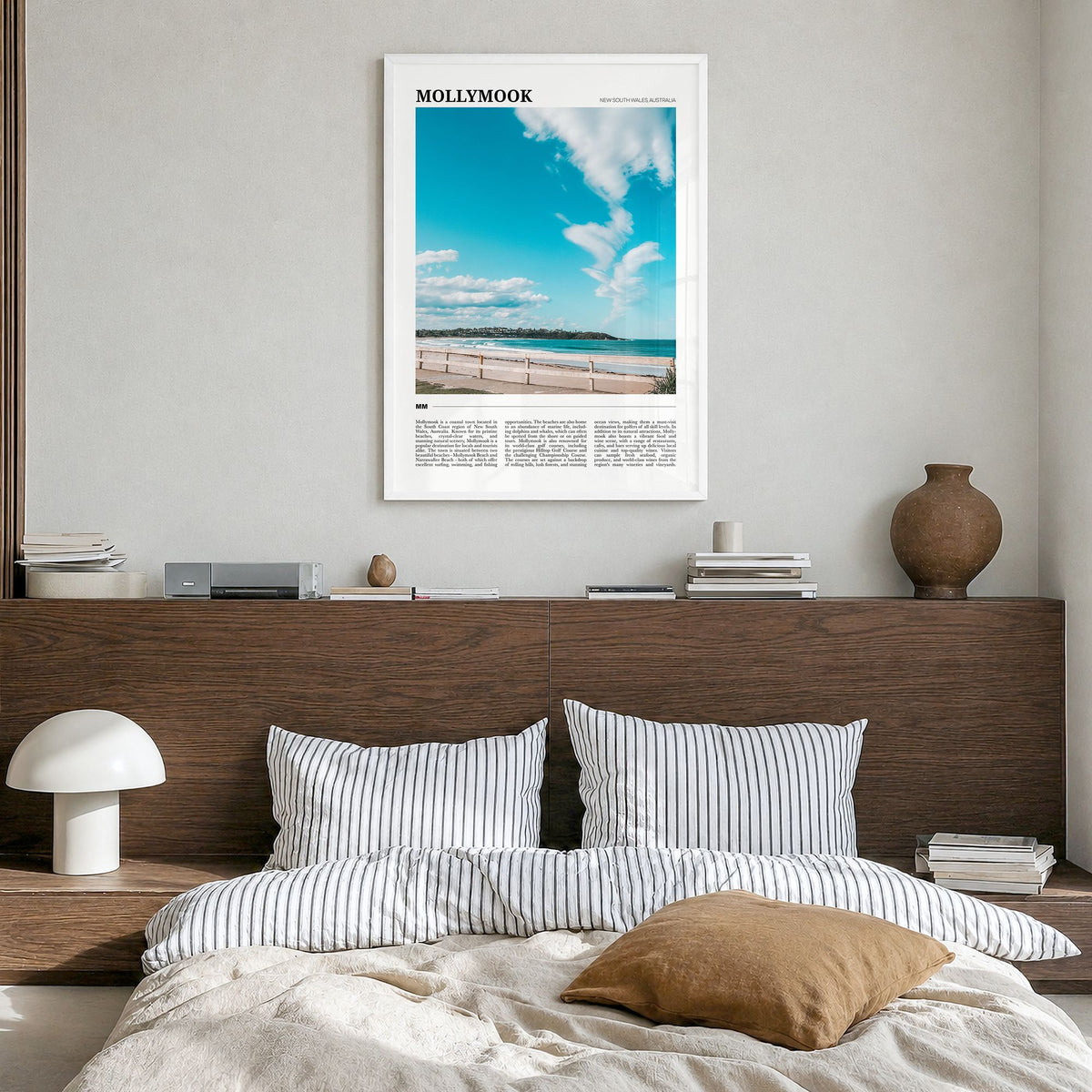 Mollymook Travel Poster in a white wood frame, hanging in a bedroom