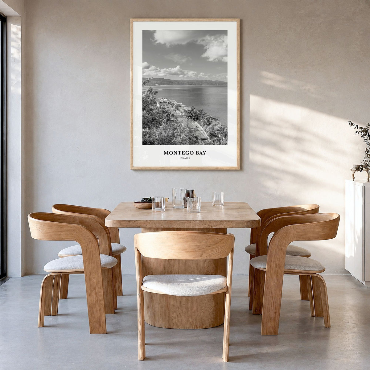 Montego Bay Classic Poster in a natural wood frame, hanging in a dining room