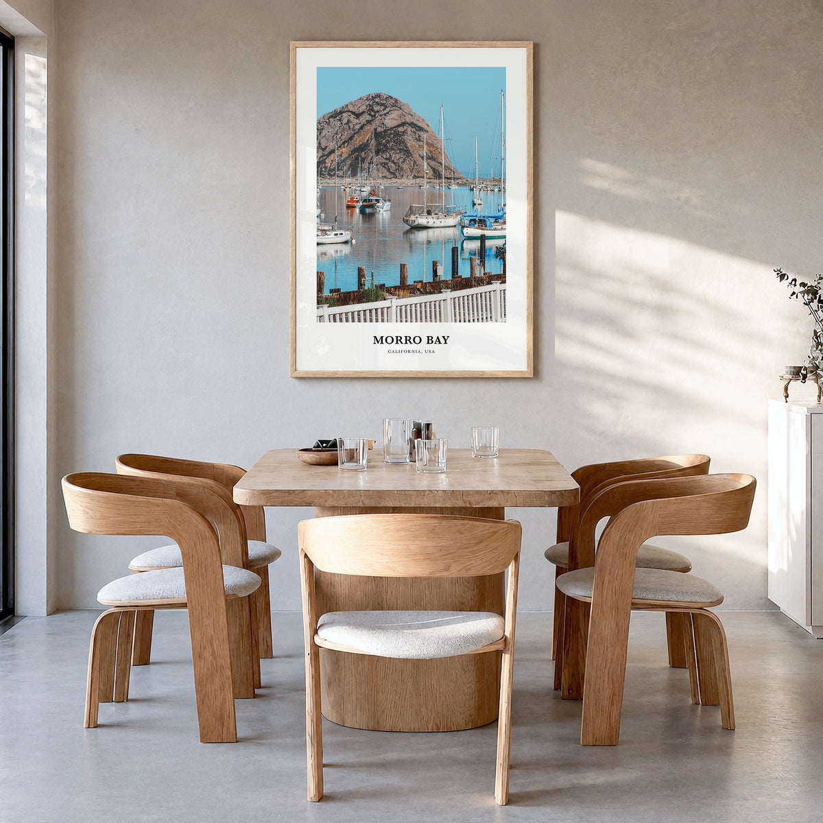 Morro Bay Classic Poster in a natural wood frame, hanging in a dining room