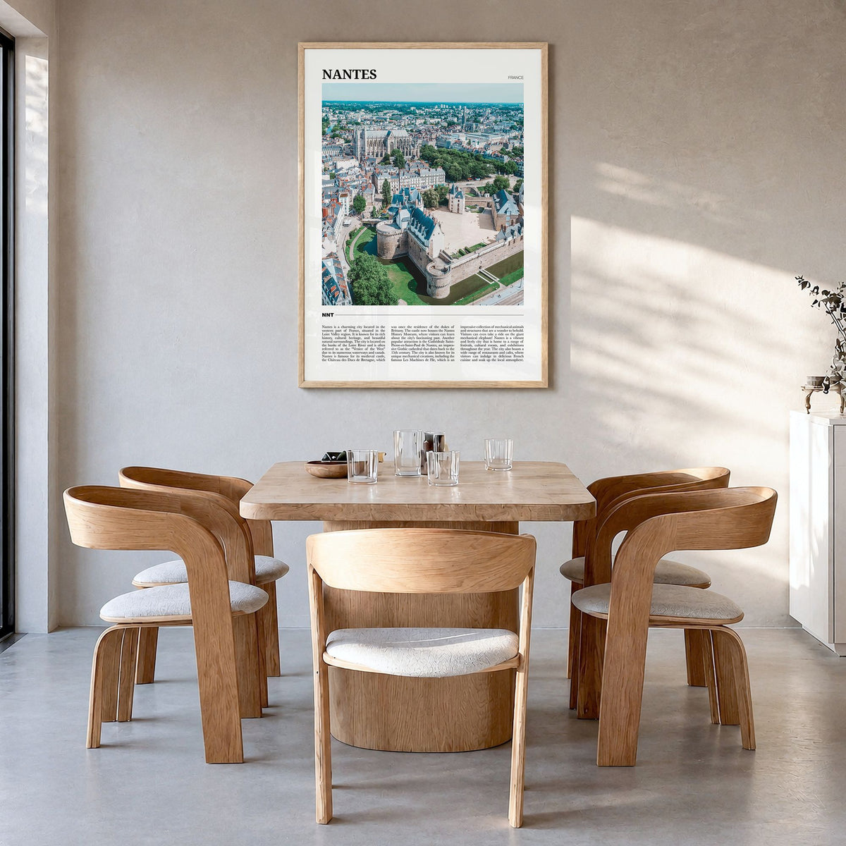Nantes Travel Poster in a natural wood frame, hanging in a dining room