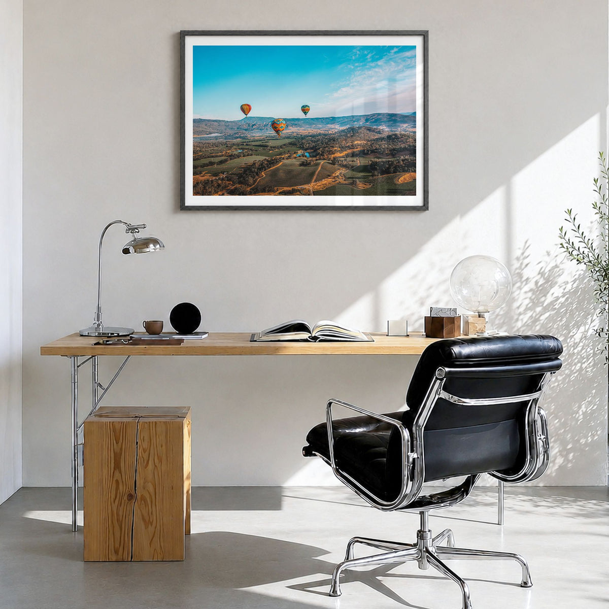 Napa Valley Photo Poster in a black wood frame, hanging in a bright home office, white border