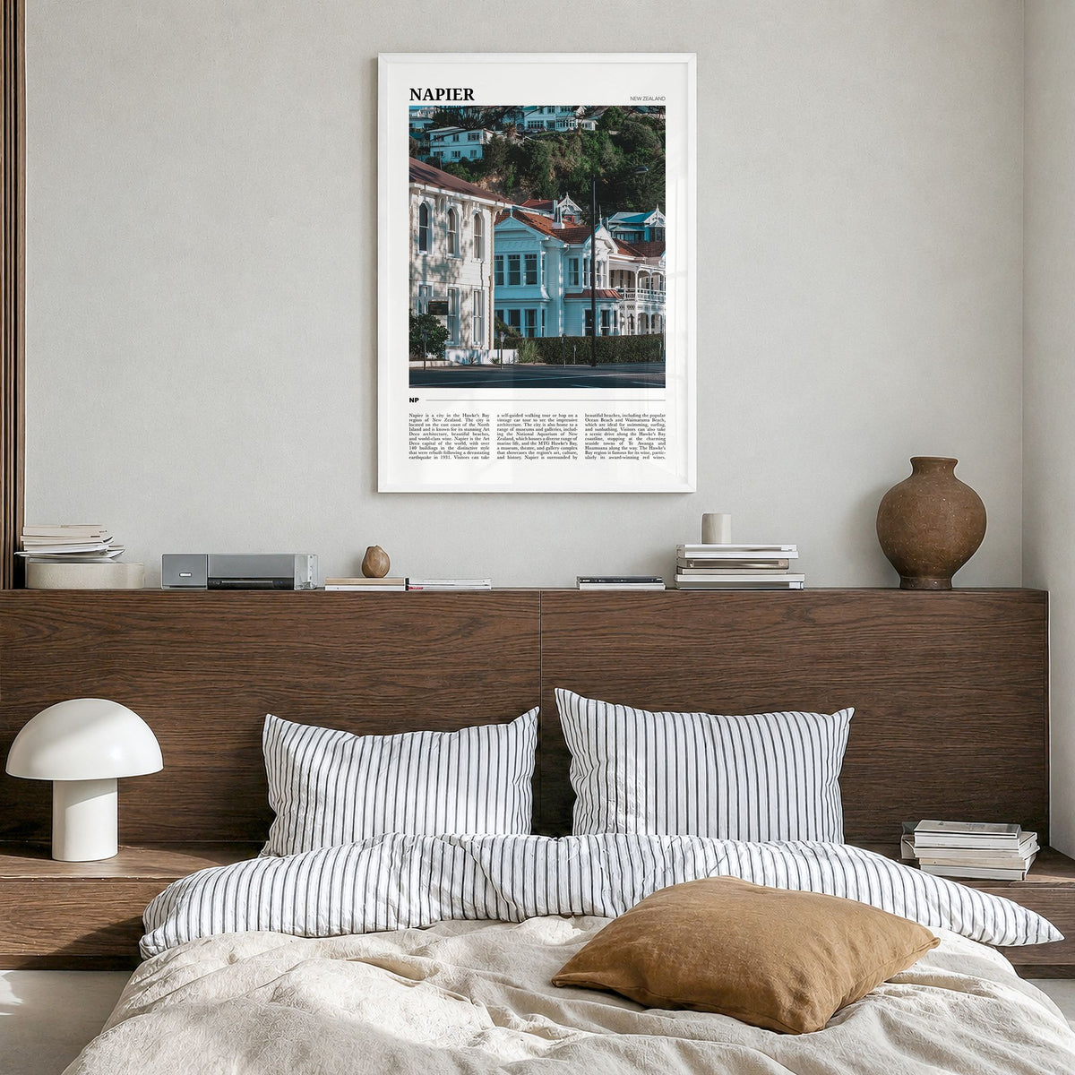 Napier Travel Poster in a white wood frame, hanging in a bedroom