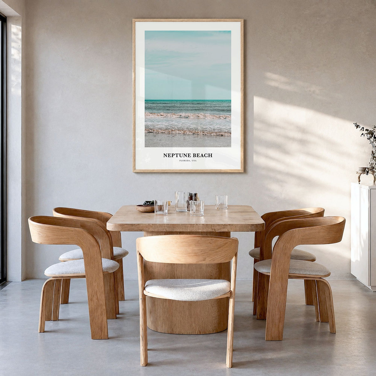Neptune Beach Classic Poster in a natural wood frame, hanging in a dining room