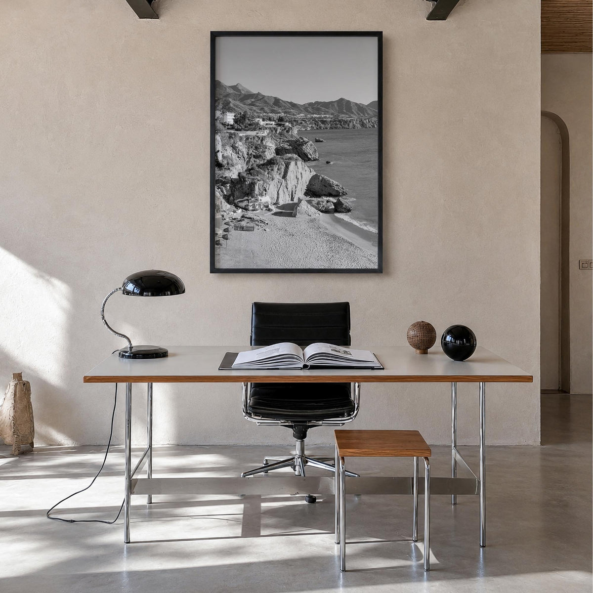Nerja black & white photo poster of Spain – vertical wall art in black wood frame, hanging on wall