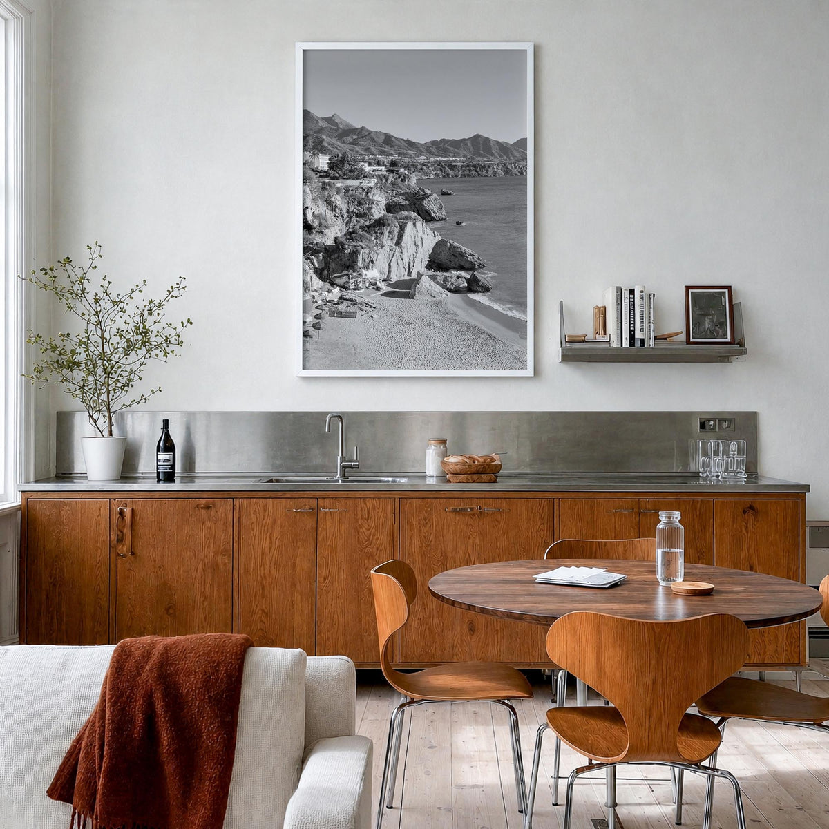 Nerja black & white photo poster of Spain – vertical wall art in white wood frame, hanging on wall
