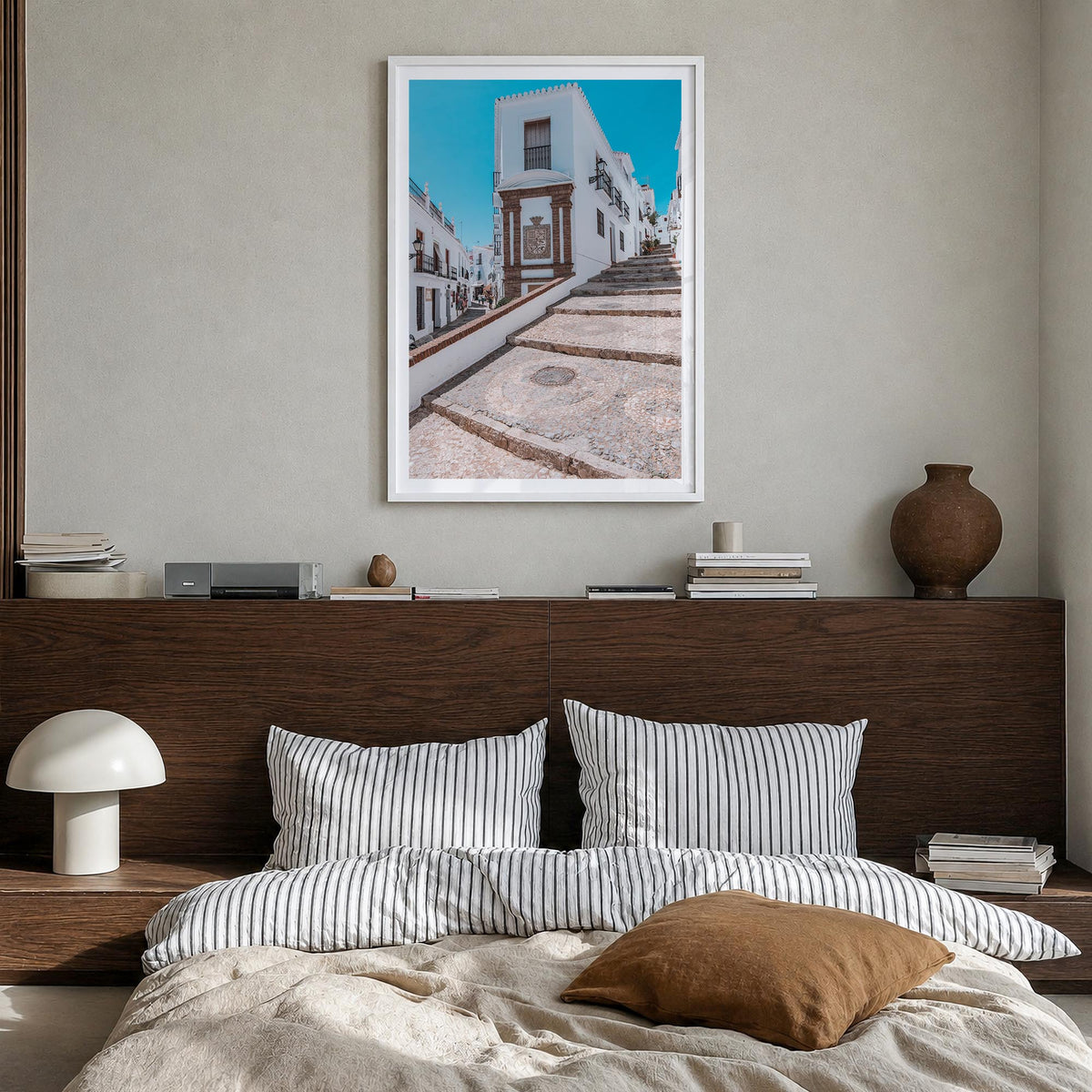 Nerja colorful photo poster of Spain – vertical wall art in white wood frame with white border, hanging on wall