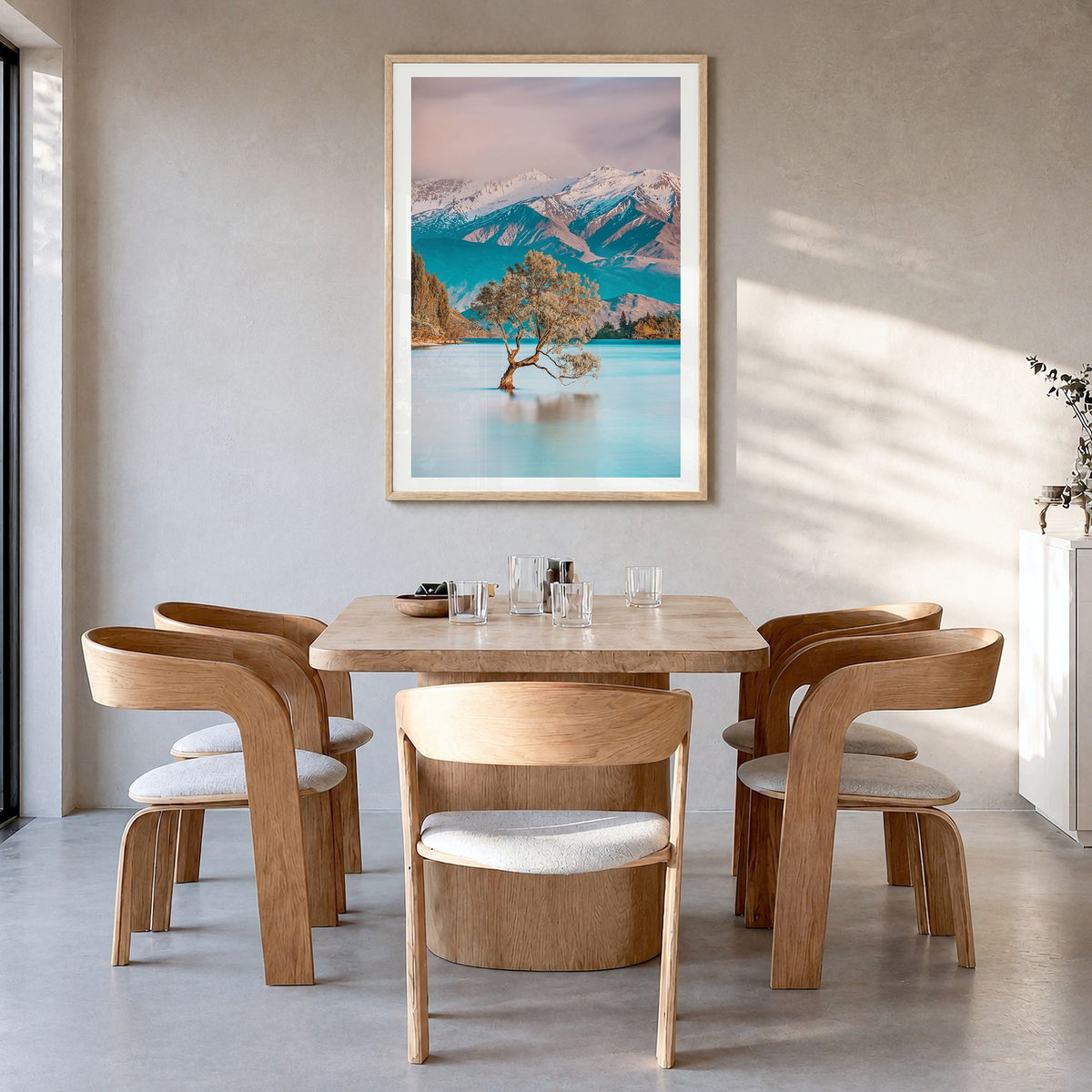 New Zealand Photo Poster in a natural wood frame, hanging in a dining room, white border