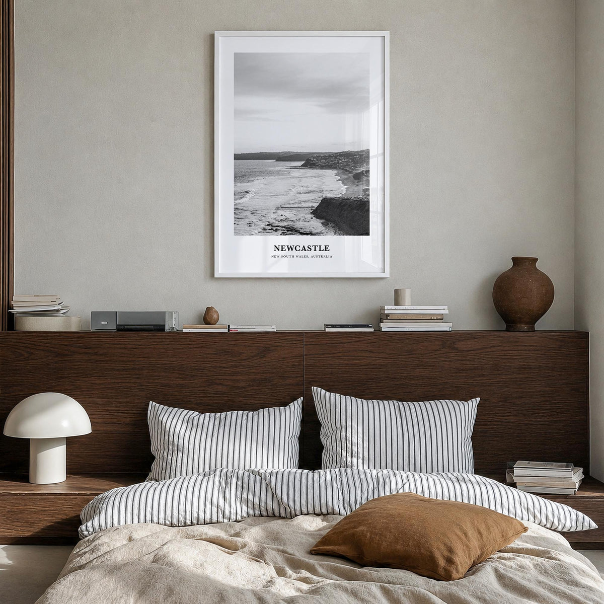 Newcastle, Australia black & white classic poster of Australia – vertical wall art in white wood frame, hanging on wall