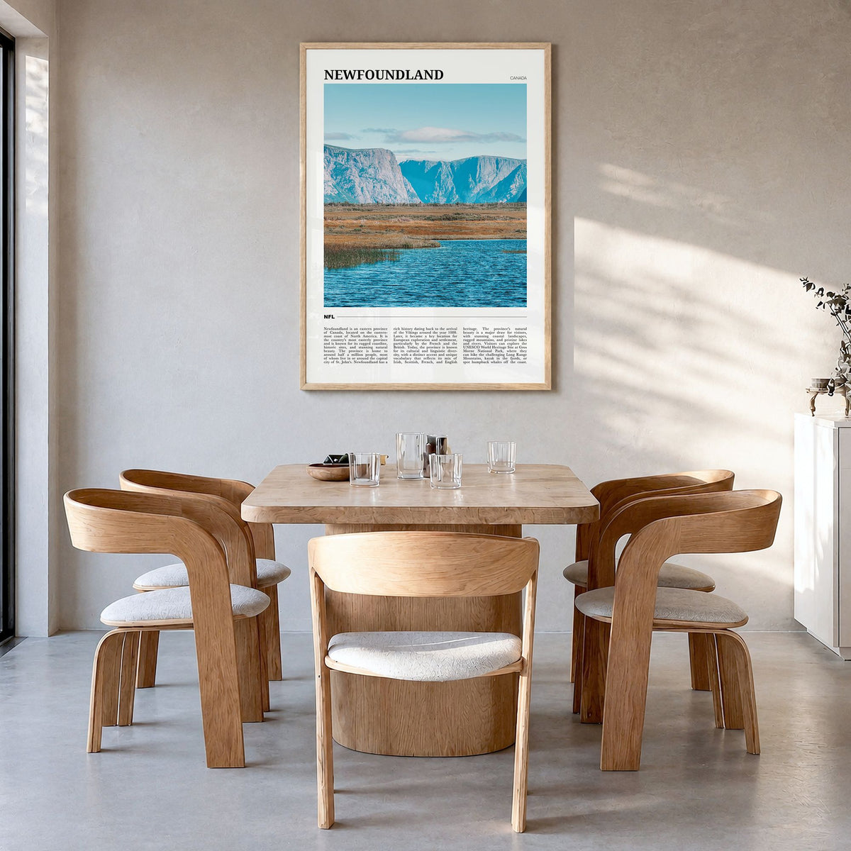 Newfoundland Travel Poster in a natural wood frame, hanging in a dining room