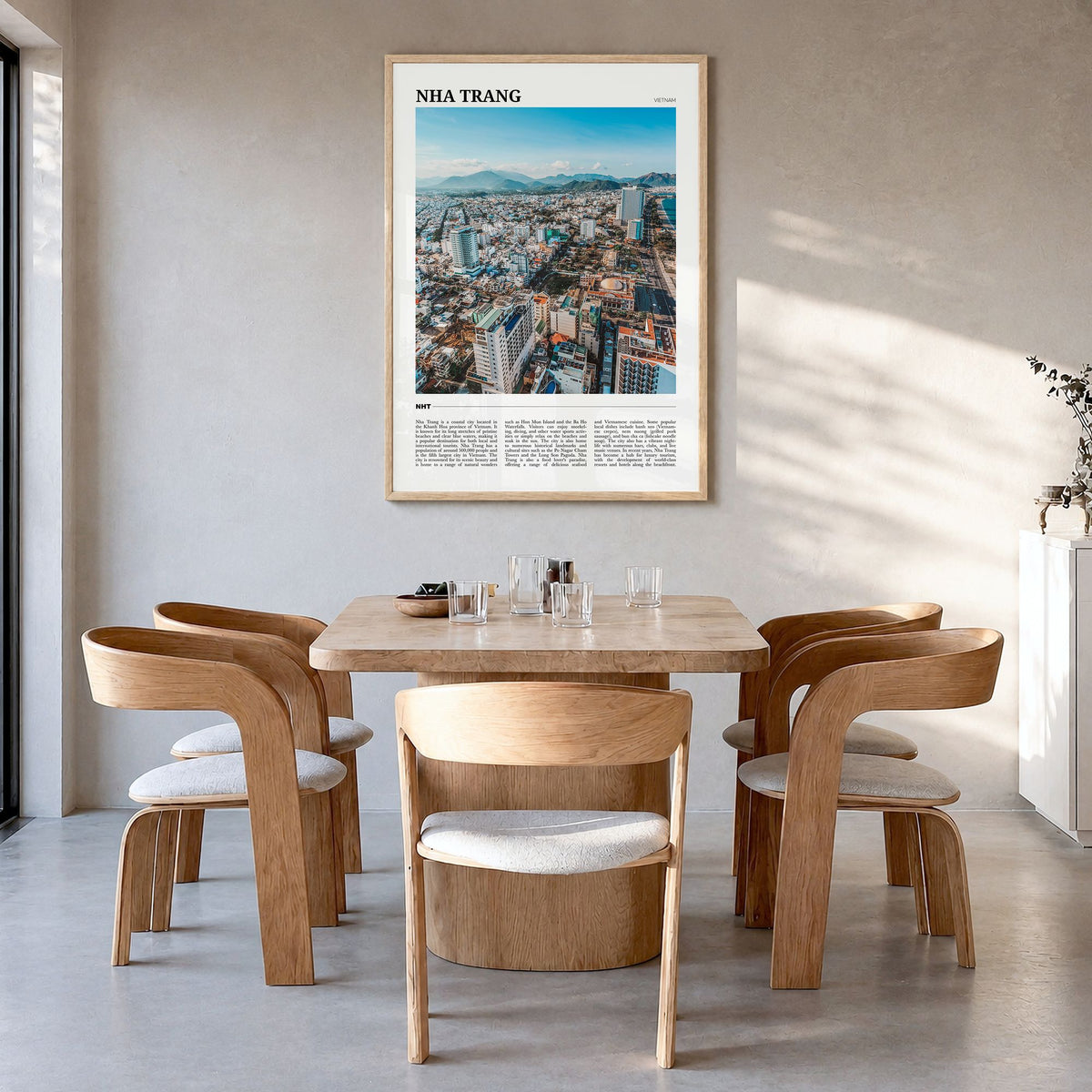 Nha Trang Travel Poster in a natural wood frame, hanging in a dining room