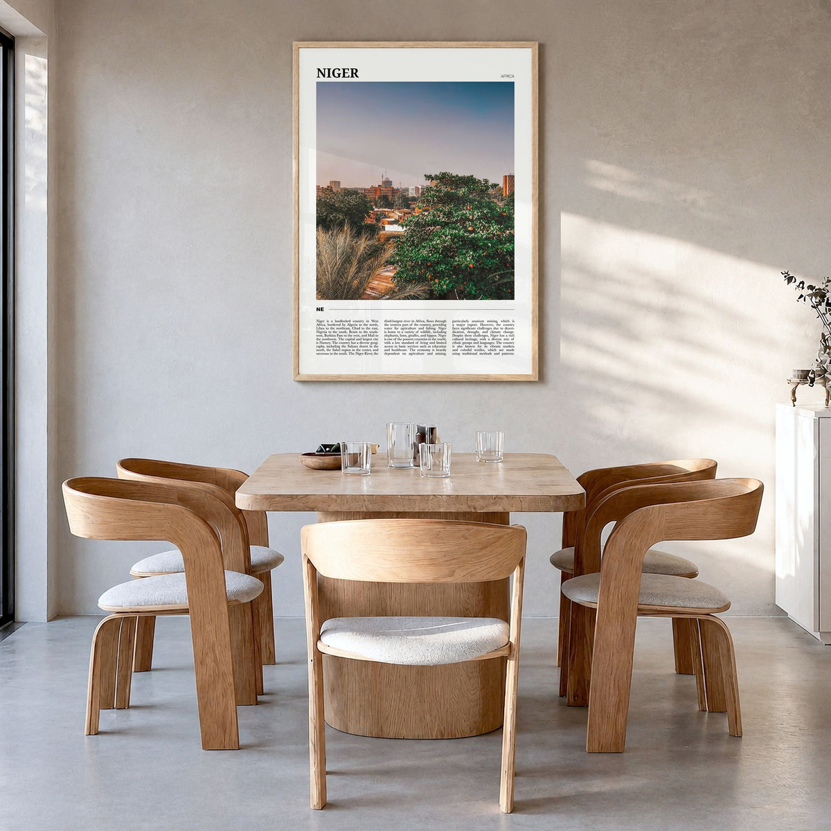 Niger Travel Poster in a natural wood frame, hanging in a dining room
