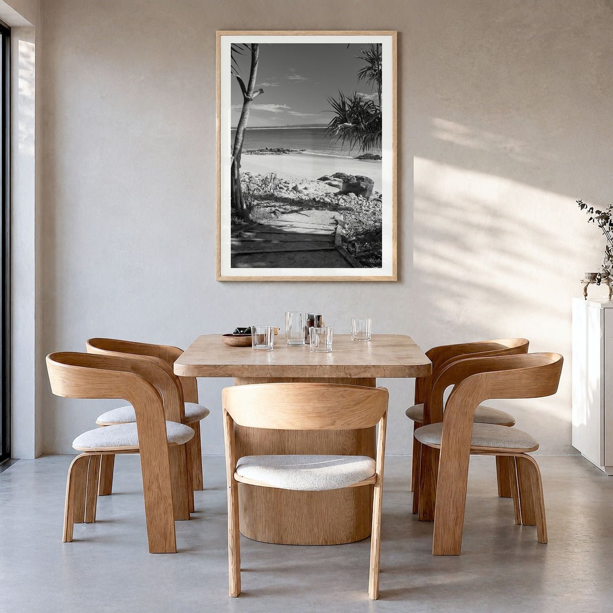 Noosa Heads Photo Poster in a natural wood frame, hanging in a dining room, white border