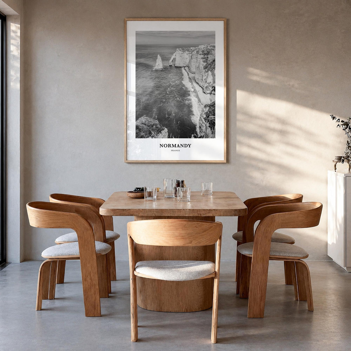 Normandy black & white classic poster of France – vertical wall art in natural wood frame, hanging on wall