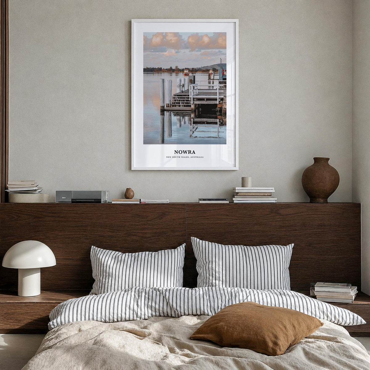 Nowra colorful classic poster of Australia – vertical wall art in white wood frame, hanging on wall