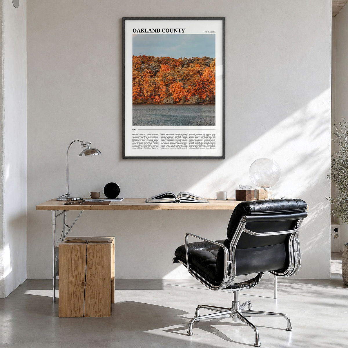 Oakland County Travel Poster in a black wood frame, hanging in a bright home office