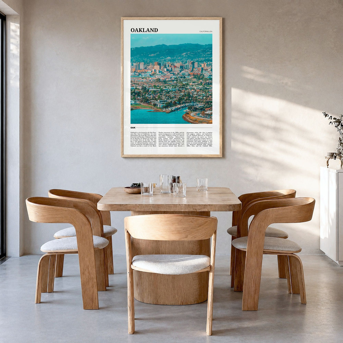 Oakland Travel Poster in a natural wood frame, hanging in a dining room