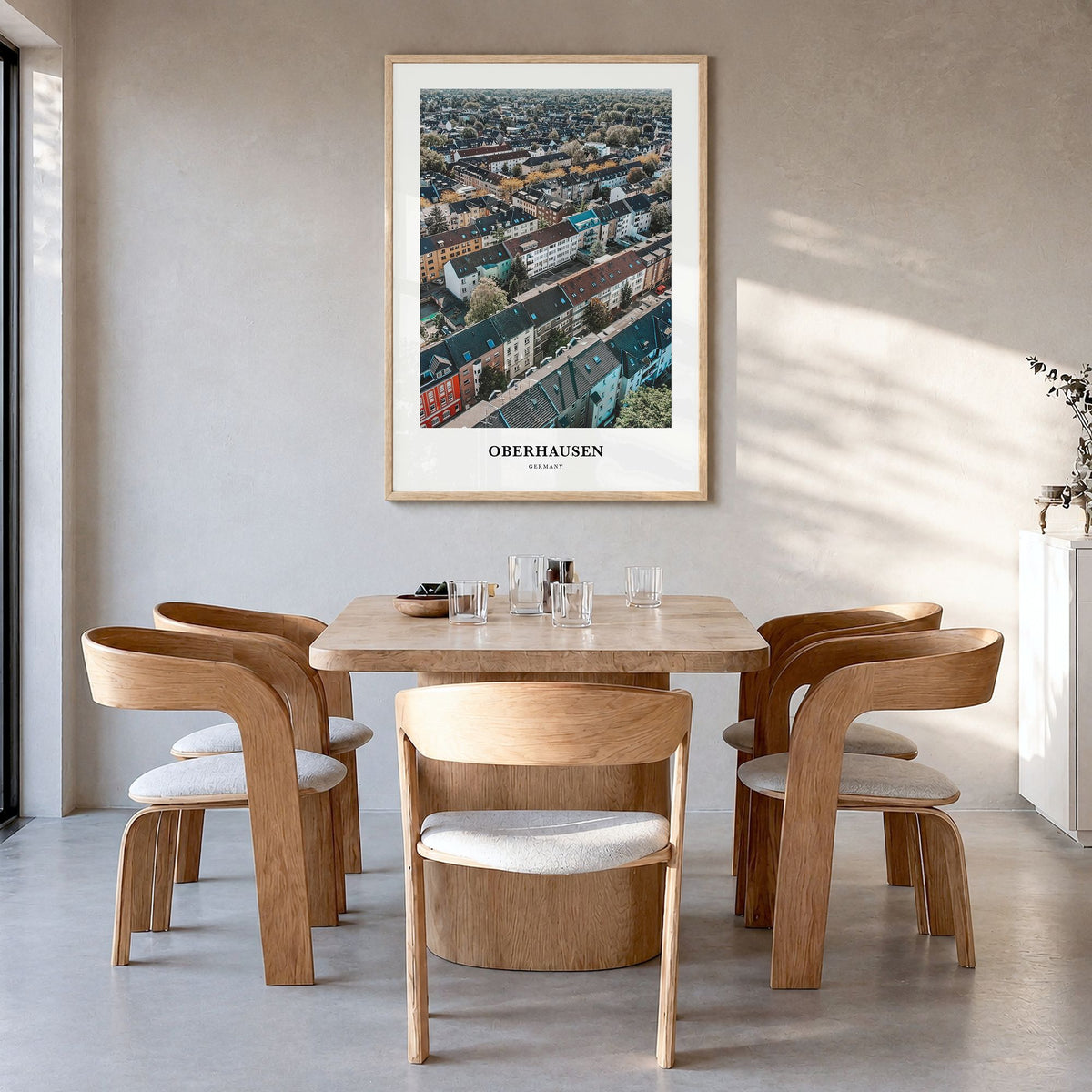 Oberhausen Classic Poster in a natural wood frame, hanging in a dining room