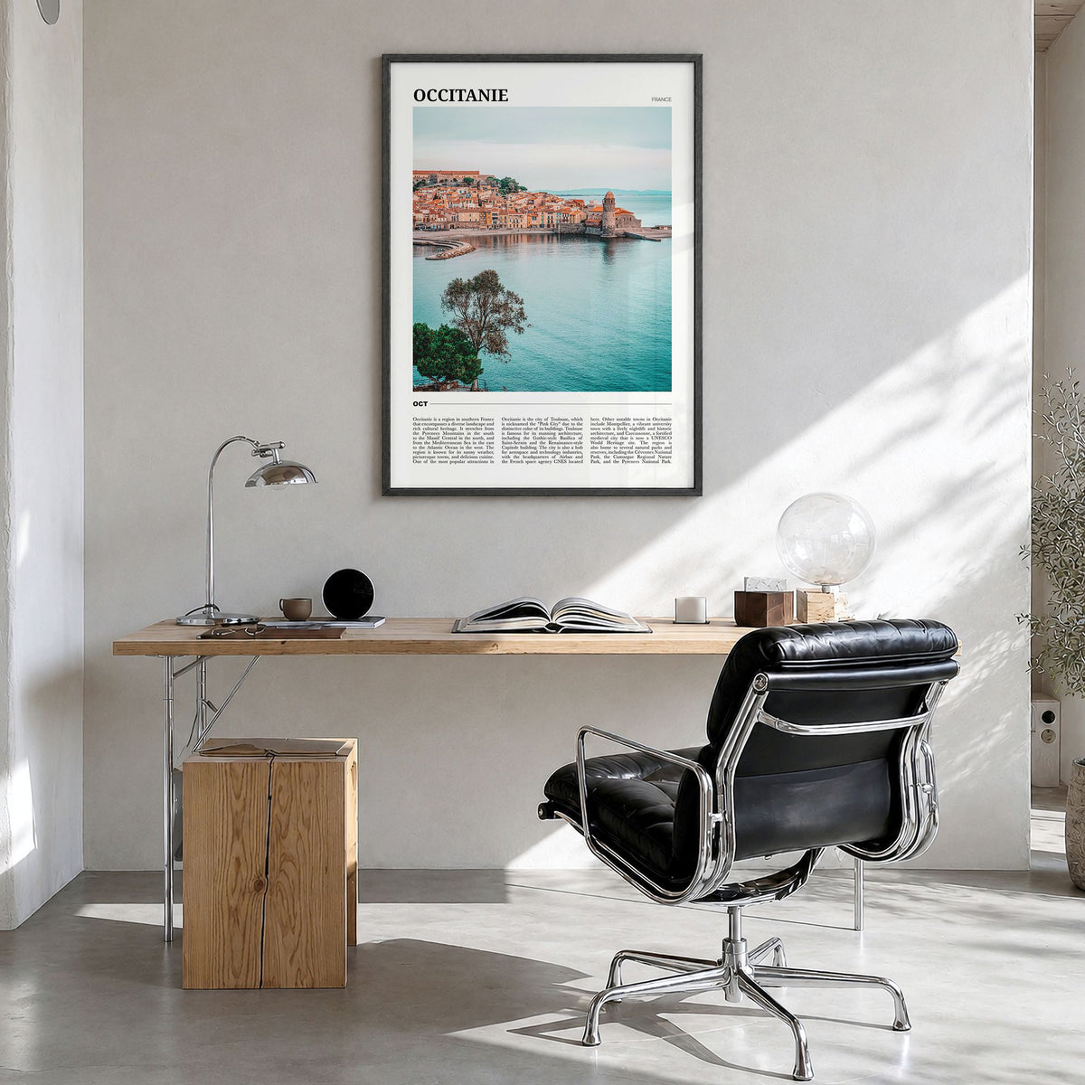 Occitanie Travel Poster in a black wood frame, hanging in a bright home office