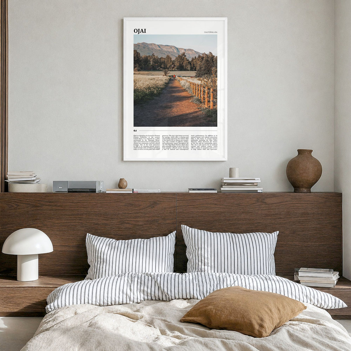 Ojai Travel Poster in a white wood frame, hanging in a bedroom