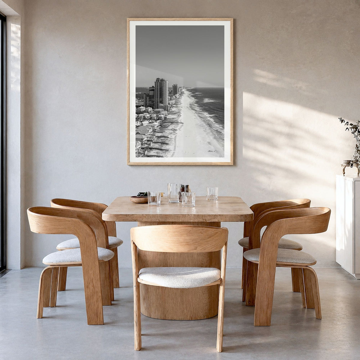 Orange Beach Photo Poster in a natural wood frame, hanging in a dining room, white border