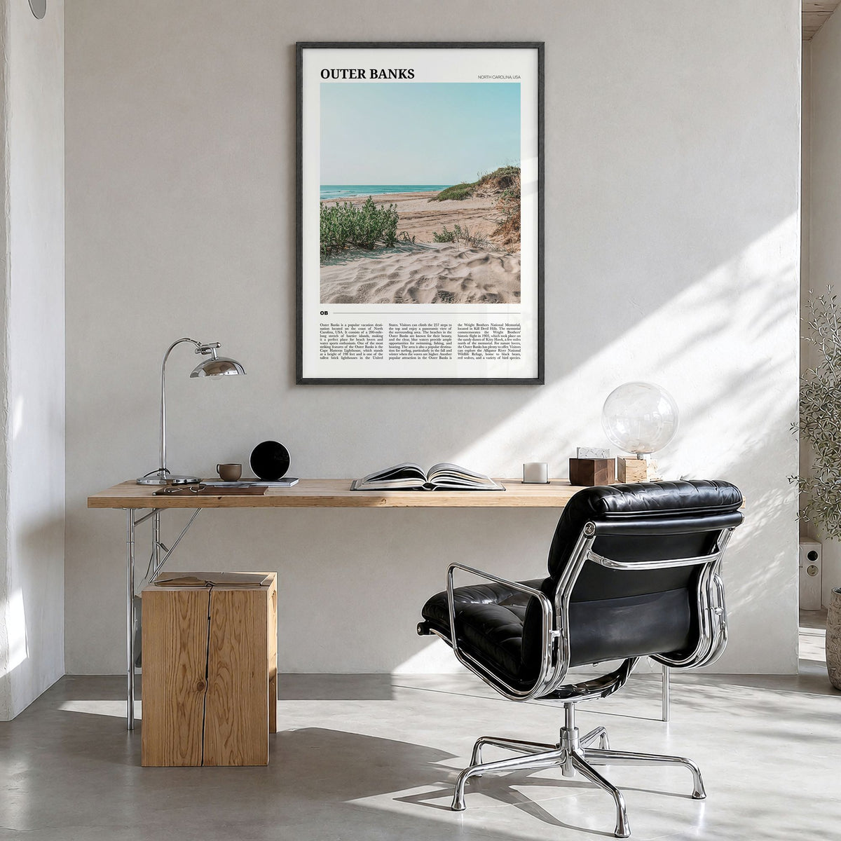Outer Banks Travel Poster in a black wood frame, hanging in a bright home office