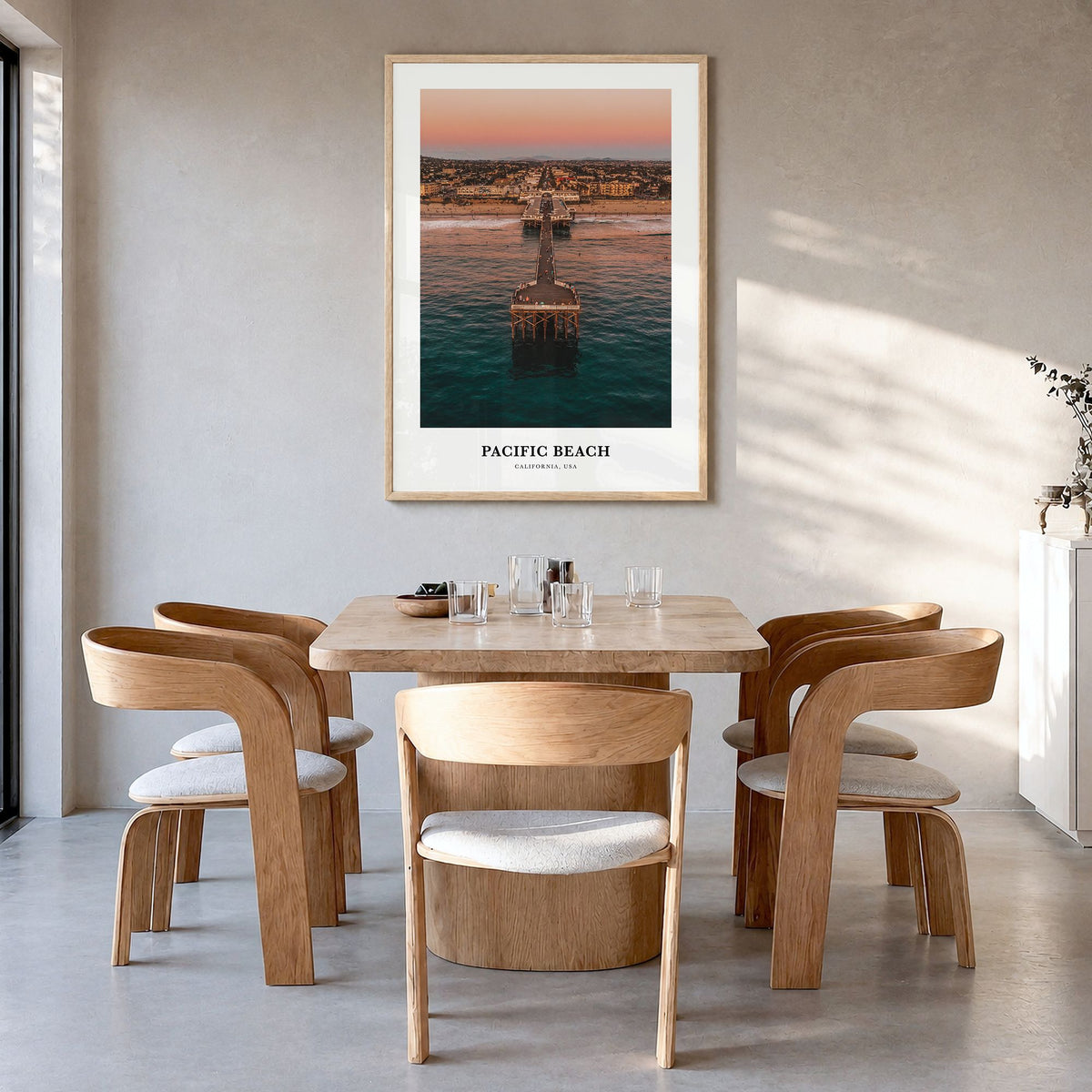 Pacific Beach Classic Poster in a natural wood frame, hanging in a dining room