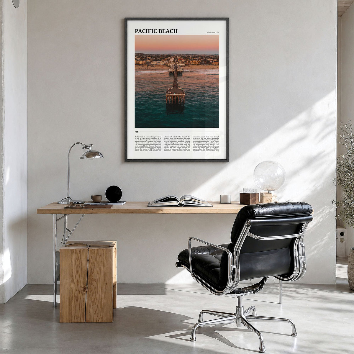 Pacific Beach Travel Poster in a black wood frame, hanging in a bright home office