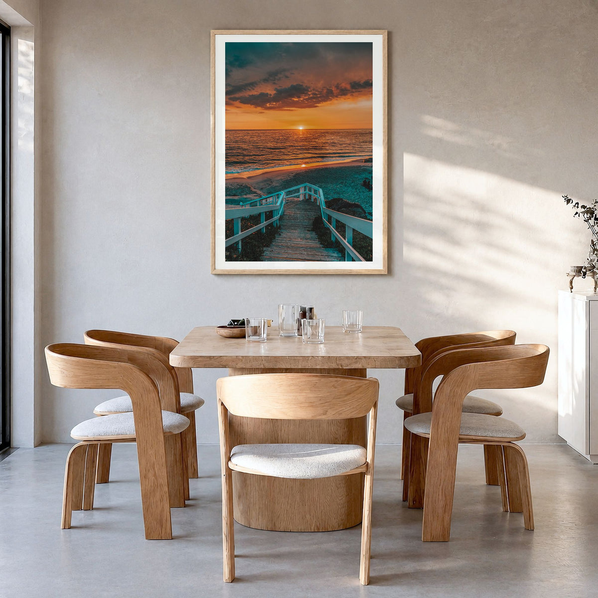 Pacific Ocean Photo Poster in a natural wood frame, hanging in a dining room, white border