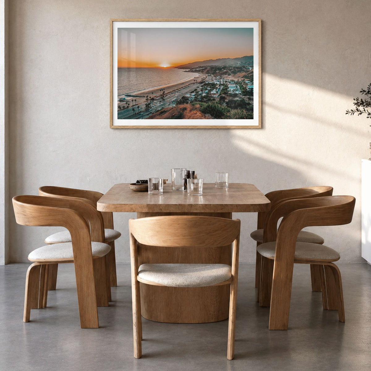 Pacific Palisades Photo Poster in a natural wood frame, hanging in a dining room, white border