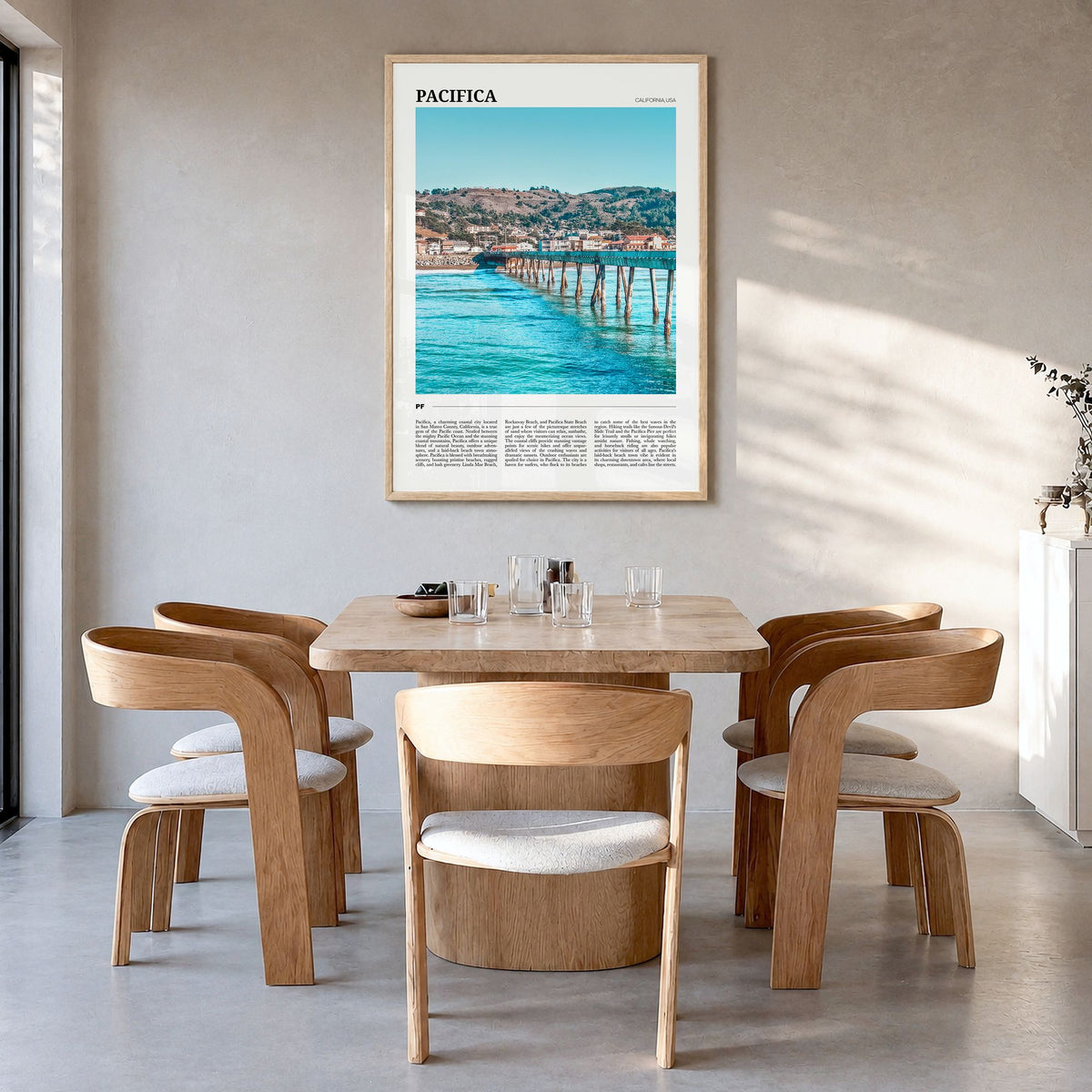 Pacifica Travel No 1 Poster in a natural wood frame, hanging in a dining room