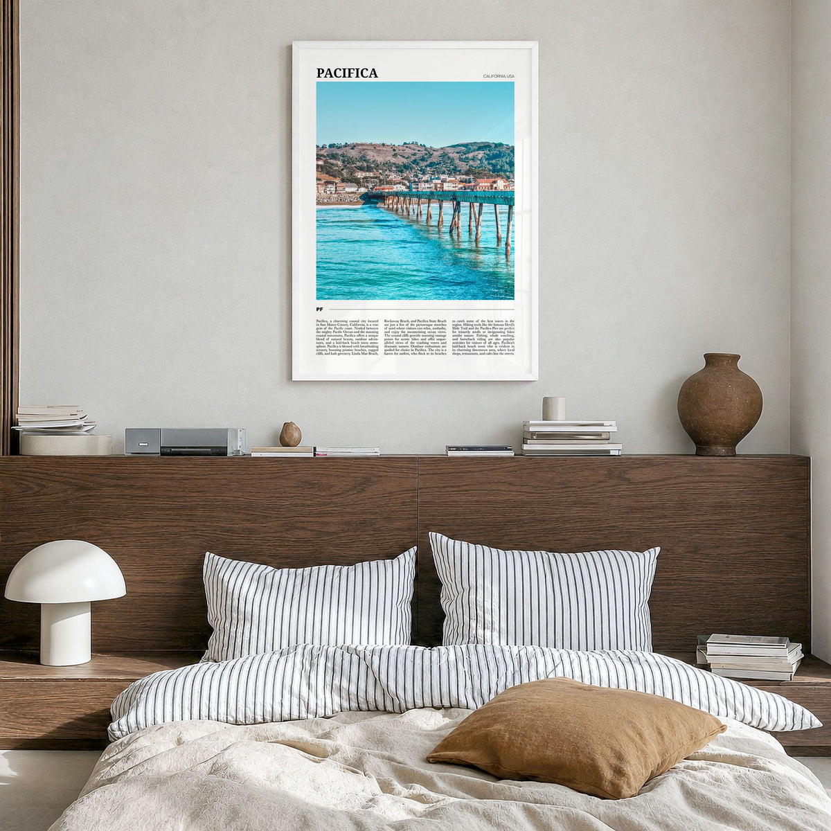 Pacifica Travel No 1 Poster in a white wood frame, hanging in a bedroom