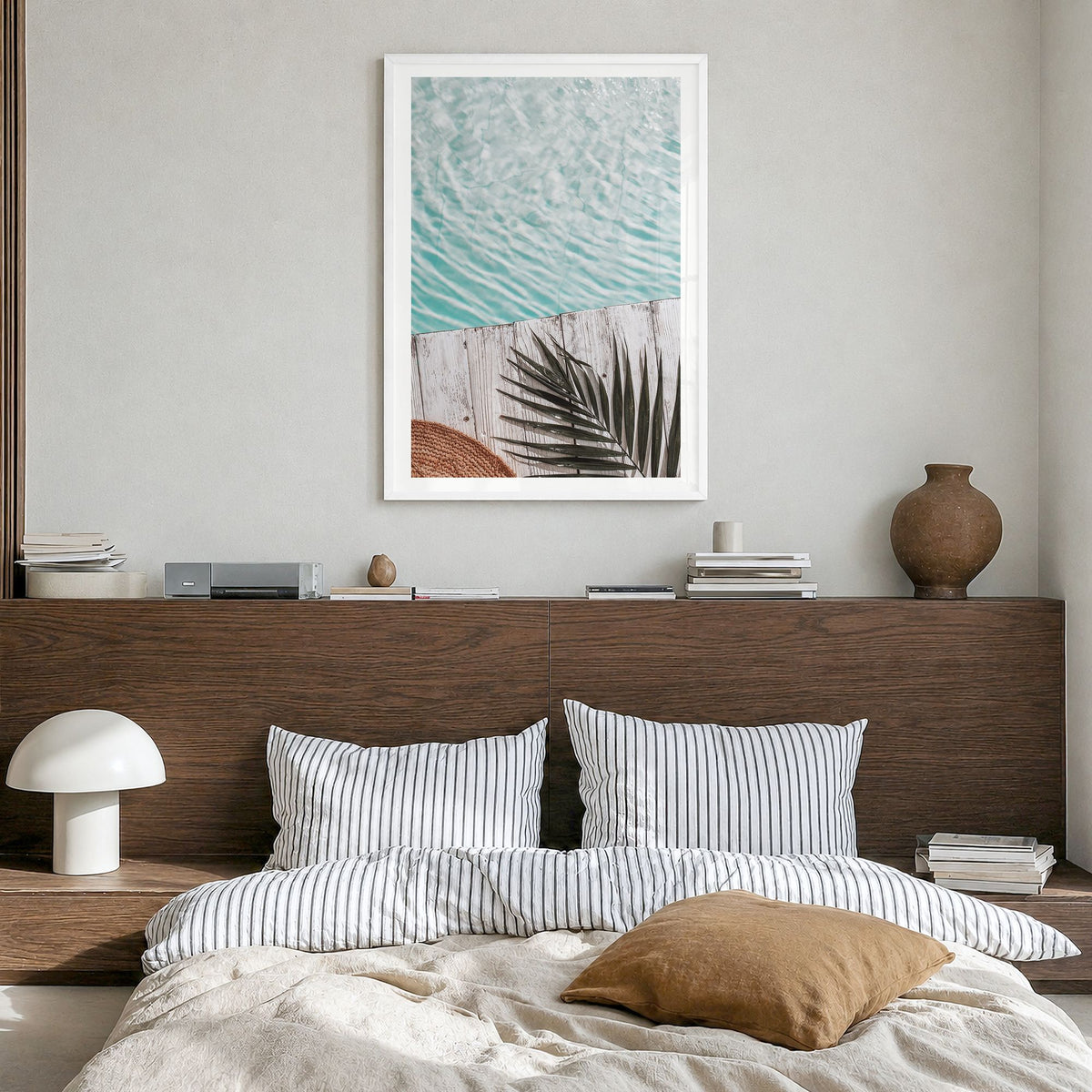 Palm Leaf Pool Photo Poster in a white wood frame, hanging in a bedroom, white border