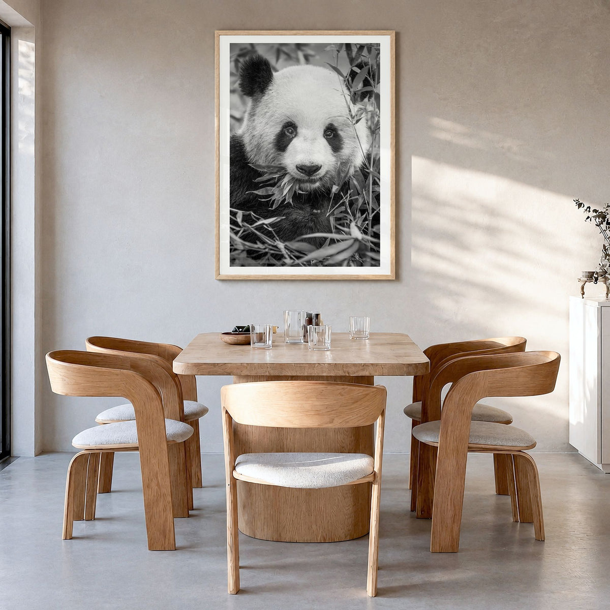 Panda Bear Photo No 1 Poster in a natural wood frame, hanging in a dining room, white border