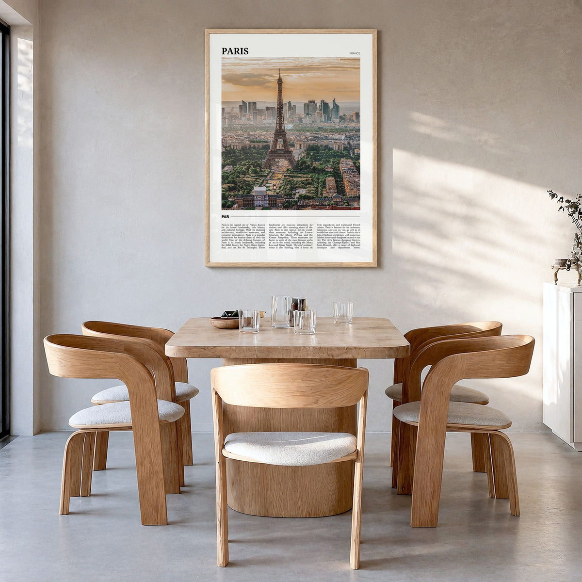 Paris Travel Poster in a natural wood frame, hanging in a dining room