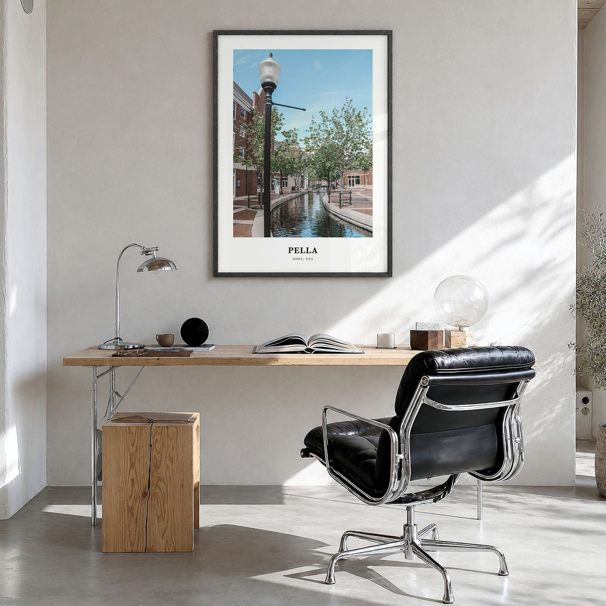 Pella, Iowa Classic Poster in a black wood frame, hanging in a bright home office