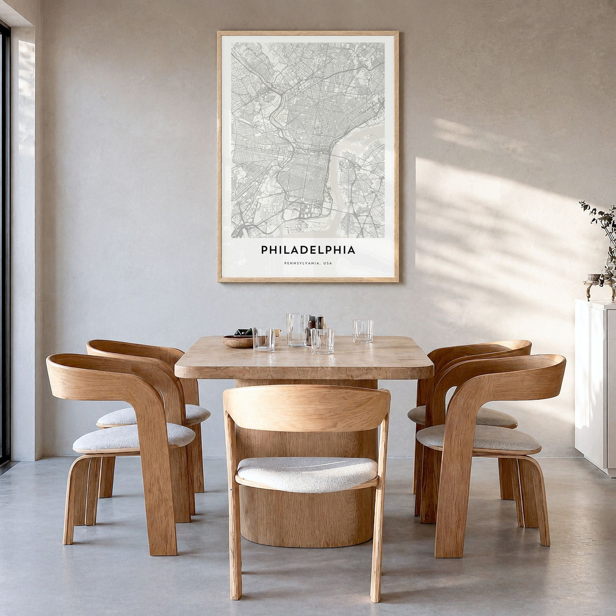 Philadelphia Map Poster in a natural wood frame, hanging in a dining room